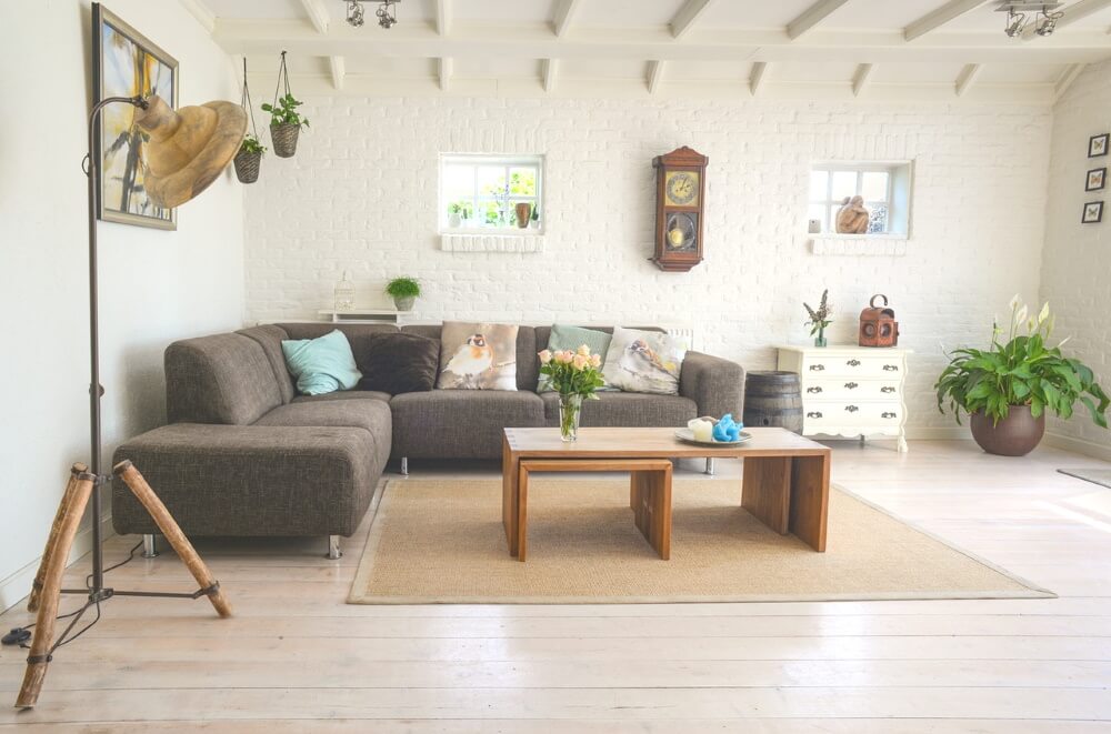 grey couch with wooden centre table